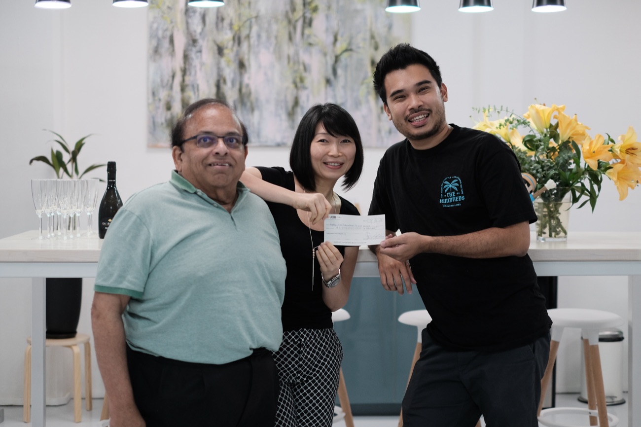 Joanna handing the first cheque to Mighty Jaxx founder Jackson Aw